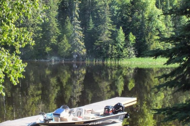 a boat floating along a river next to a body of water